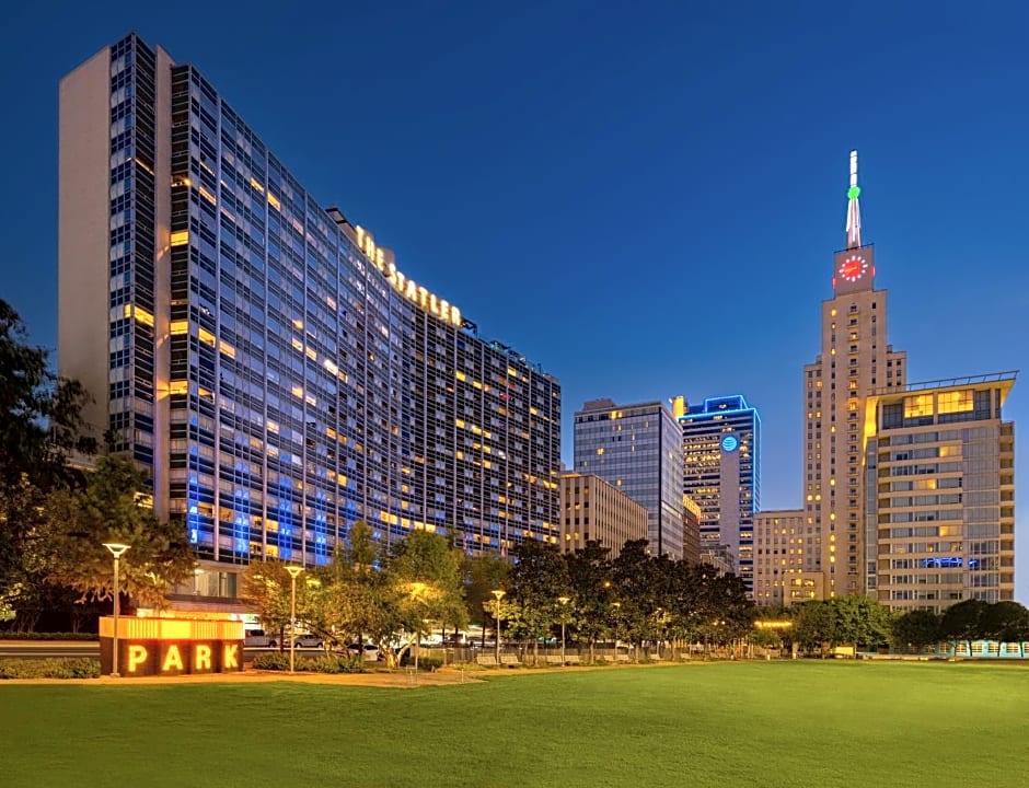 The Statler Dallas, Curio Collection by Hilton venue. Tall buildings and bright lights.